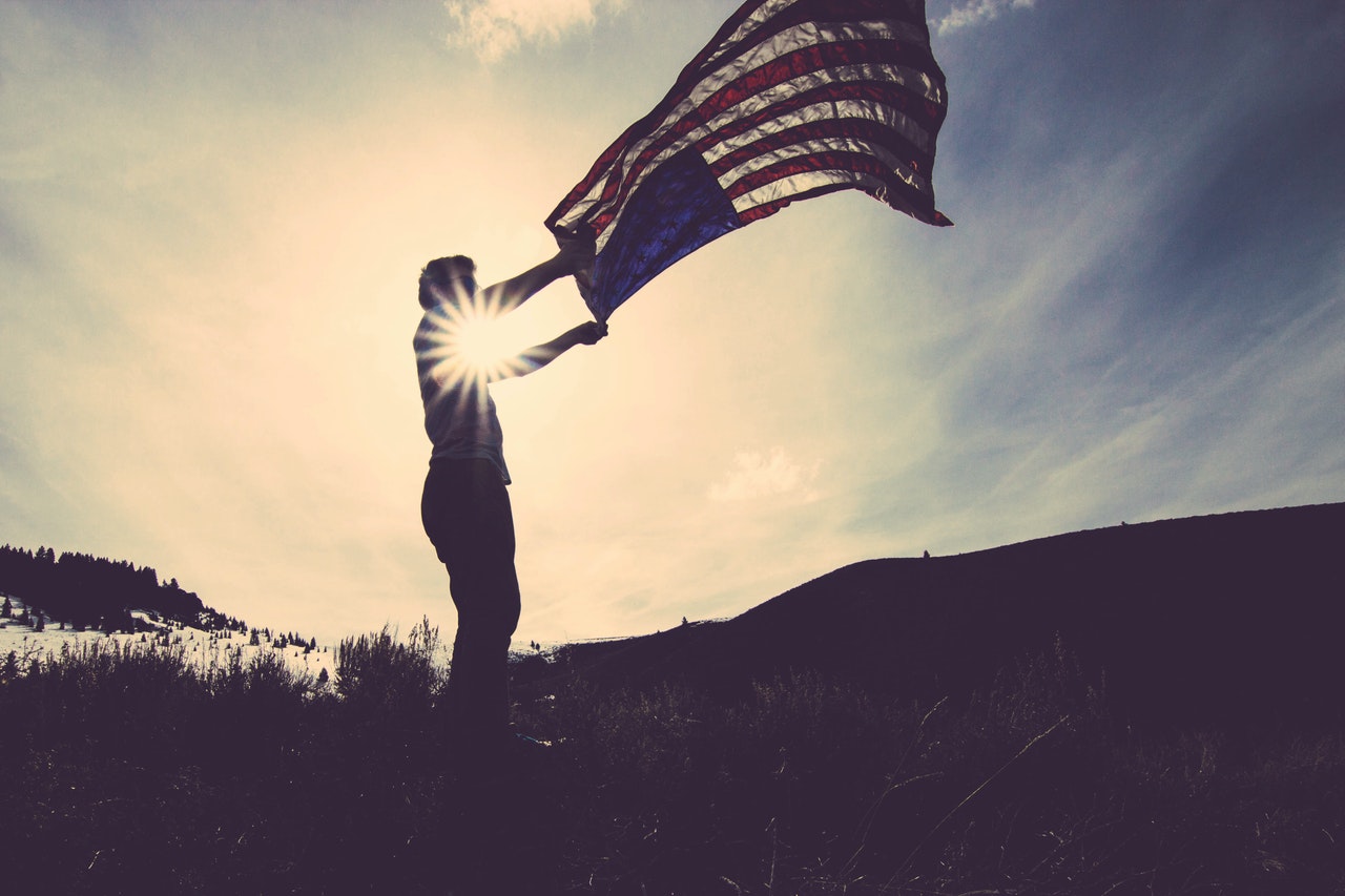 Man Waving the US National Flag | Veteran Car Donations