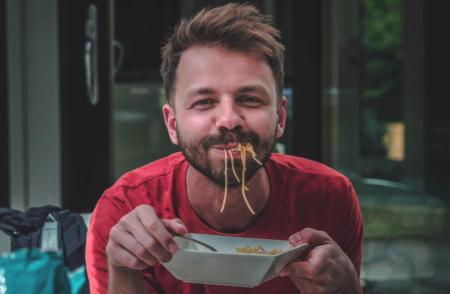 Person Enjoying a Bowl of Noodles | Veteran Car Donations