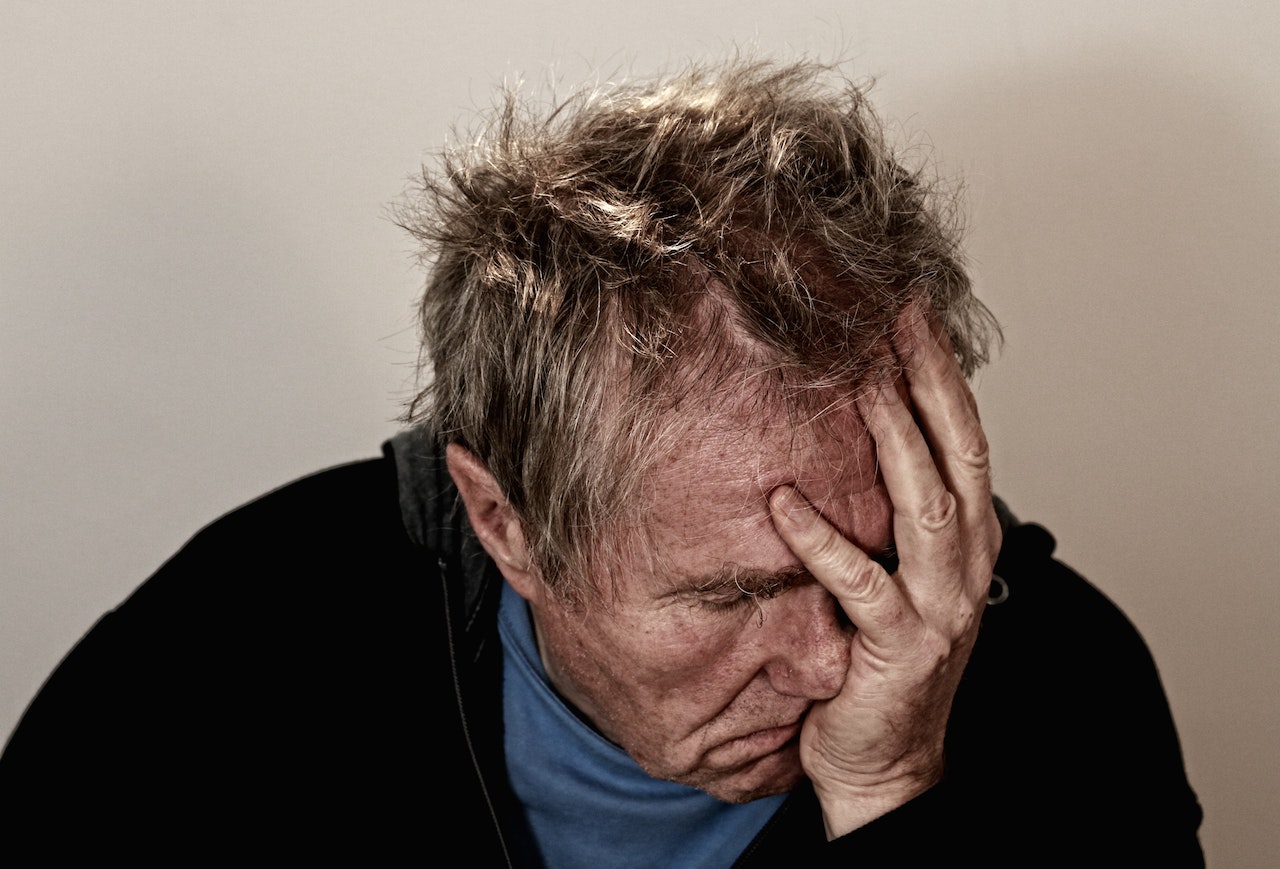 Man Holding His Face | Veteran Car Donations