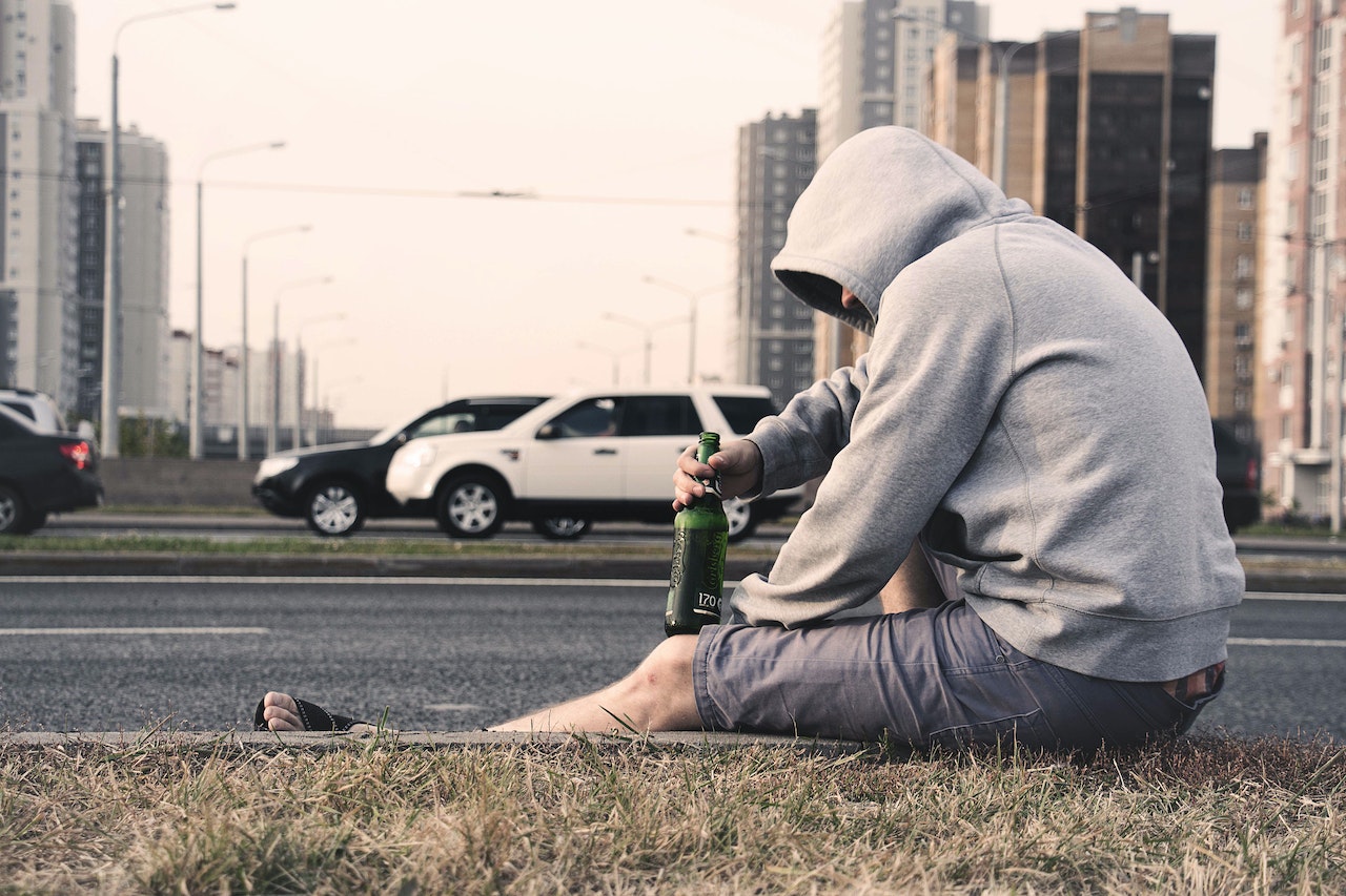 Person in Gray Hoodie Holding Beer | Veteran Car Donations