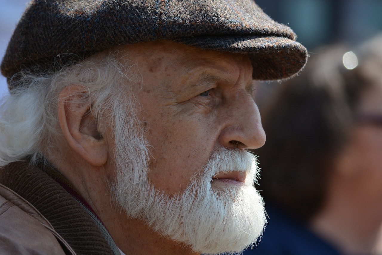 Selective Focus Photography of Man in Flat Cap during Daytime | Veteran Car Donations