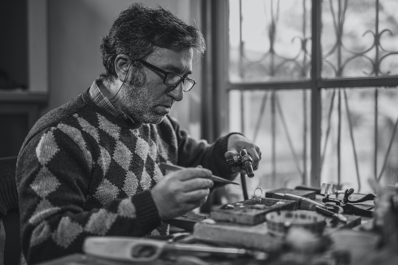 Grayscale Photo of Man Holding Tools | Veteran Car Donations
