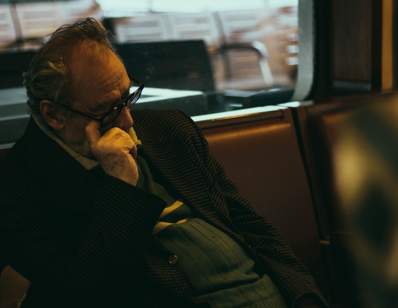 Man in Black Jacket Sitting on Chair | Veteran Car Donations
