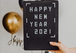 Person Holding A Happy New Year Text On A Black Board | Veteran Car Donations