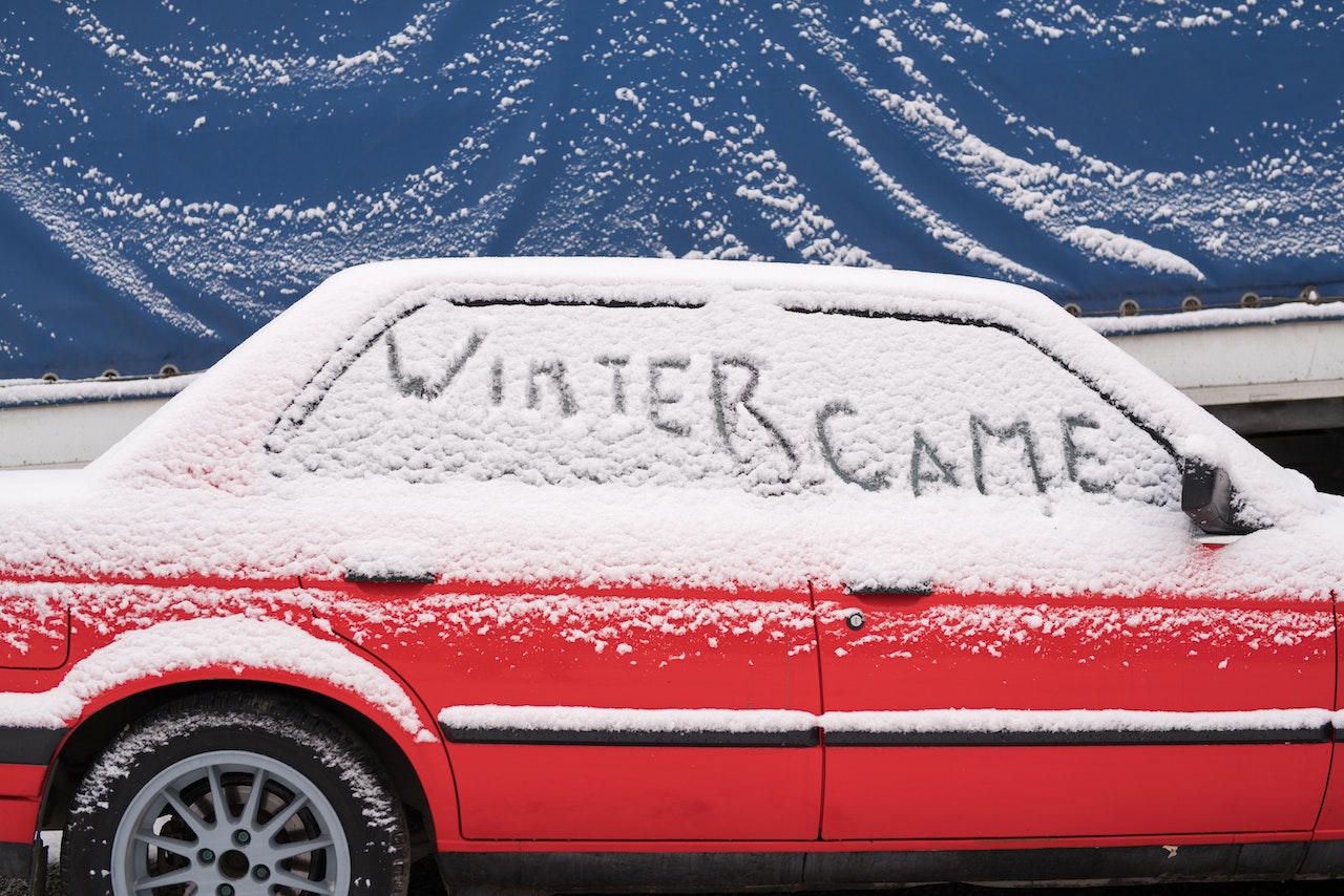 Red Car Covered with Snow | Veteran Car Donations