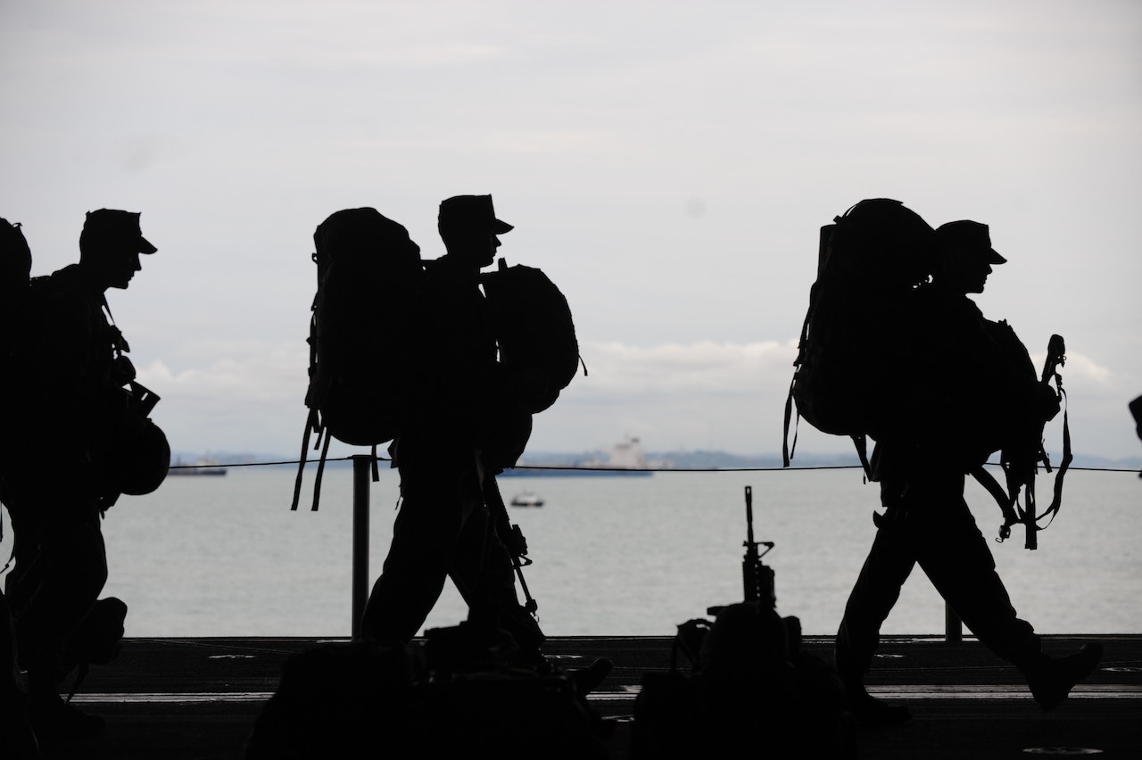 Silhouette of Soldiers Walking | Veteran Car Donations