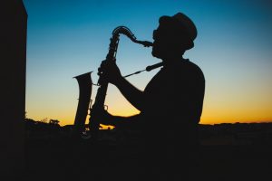 Man Playing Saxophone in Silhouette | Veteran Car Donations