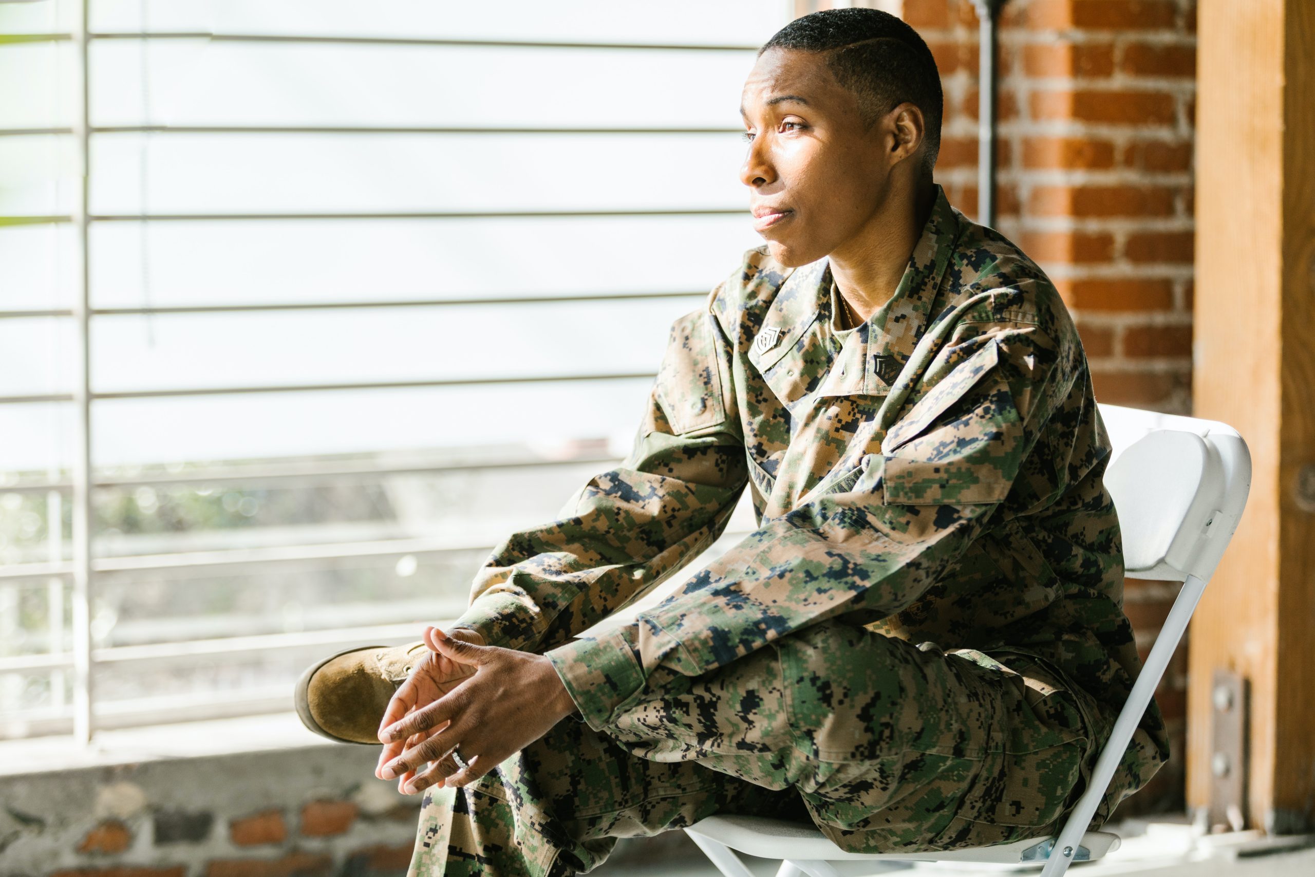 Side View Photo of Soldier Sitting on a Folding Chair | Veteran Car Donations