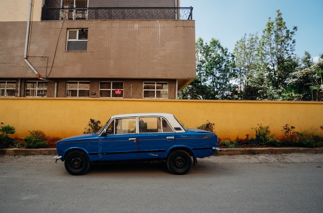 Old Blue sedan on street | Veteran Car Donations