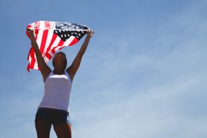 Person Holding the US Flag | Veteran Car Donations