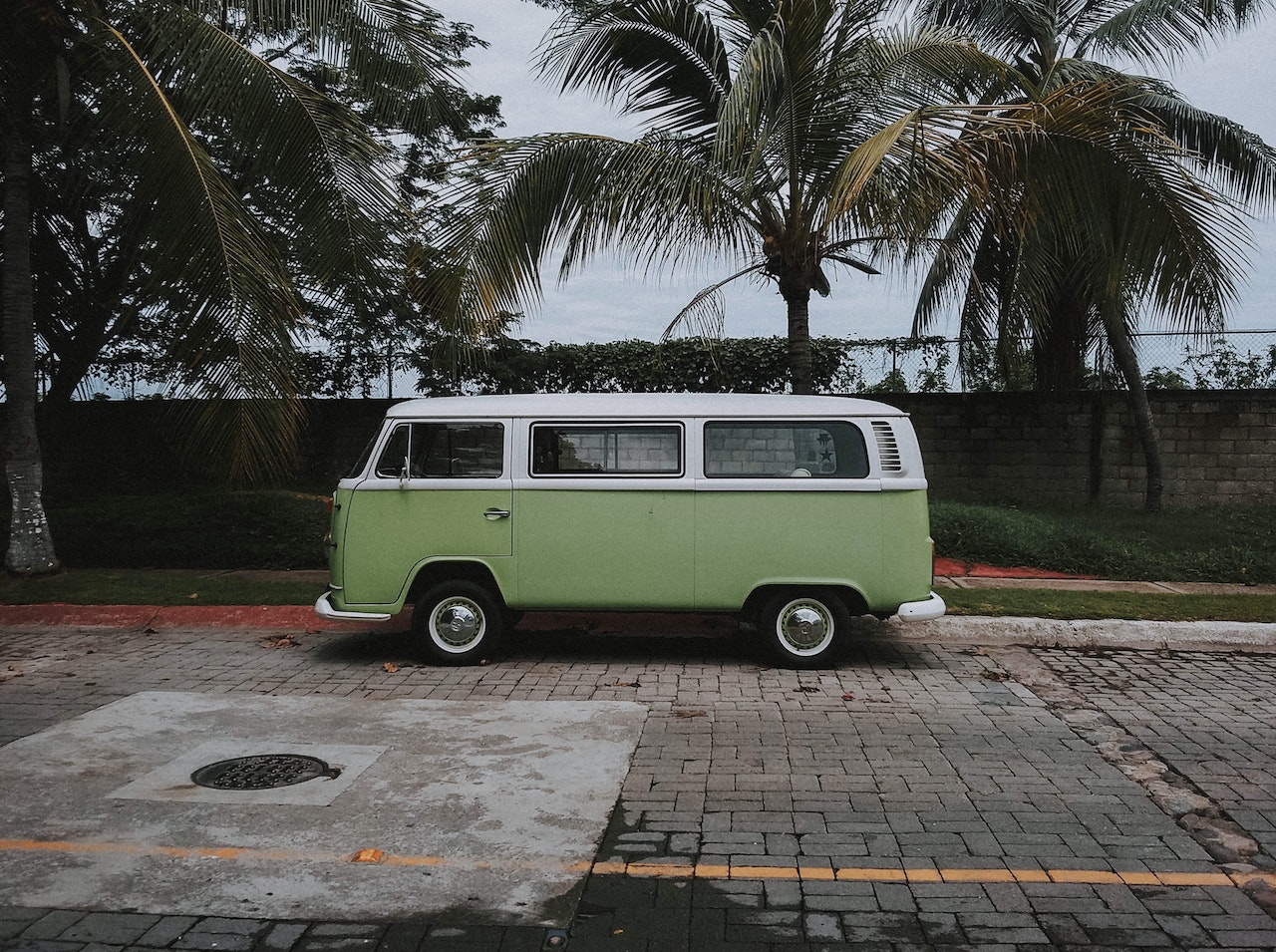 Green Volkswagen Transporter Van Parked Under Coconut Trees | Veteran Car Donations
