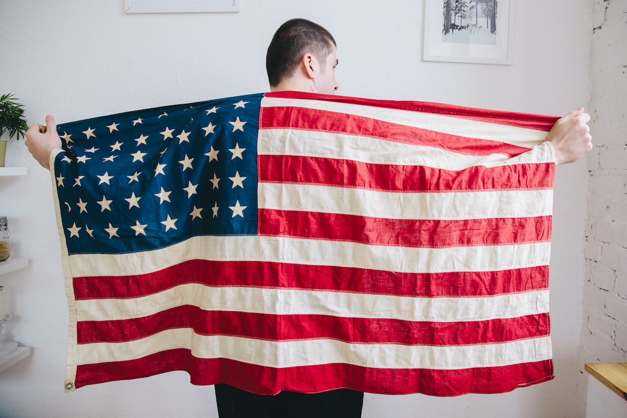Man Holding USA Flag | Veteran Car Donations
