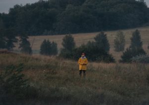 Man Standing Alone on a Grass field | Veteran Car Donations