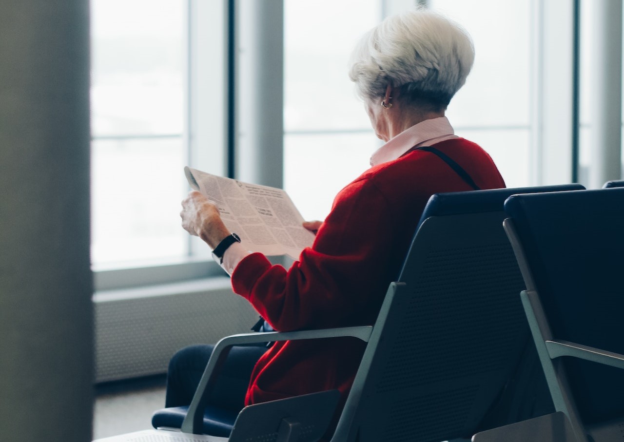 Person In Red Coat Sitting On Chair | Veteran Car Donations
