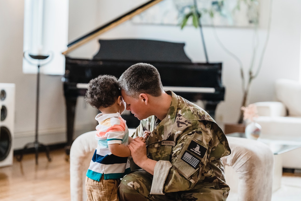 A Soldier Holding Hands with her Son | Veteran Car Donations