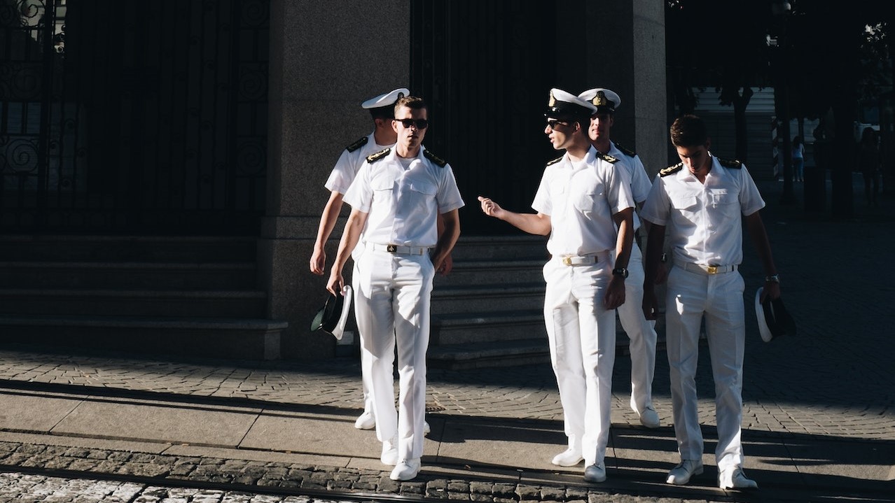 Five Navy Officers Standing Near Building | Veteran Car Donations