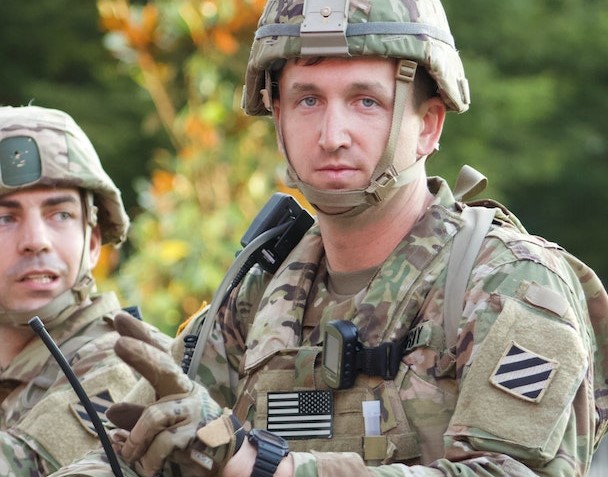 A Man in Green and Brown Camouflage Uniform | Veteran Car Donations
