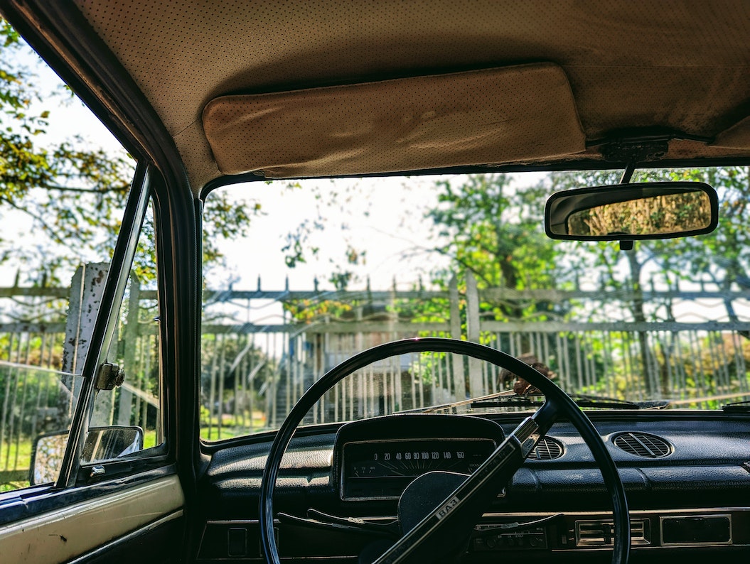 Black Steering Wheel in Old Car | Veteran Car Donations
