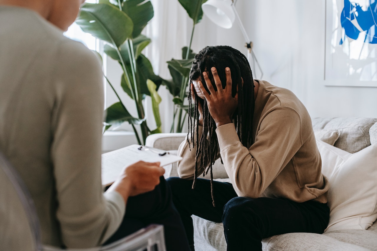 Stressed black man with dreadlocks in psychological office | Veteran Car Donations