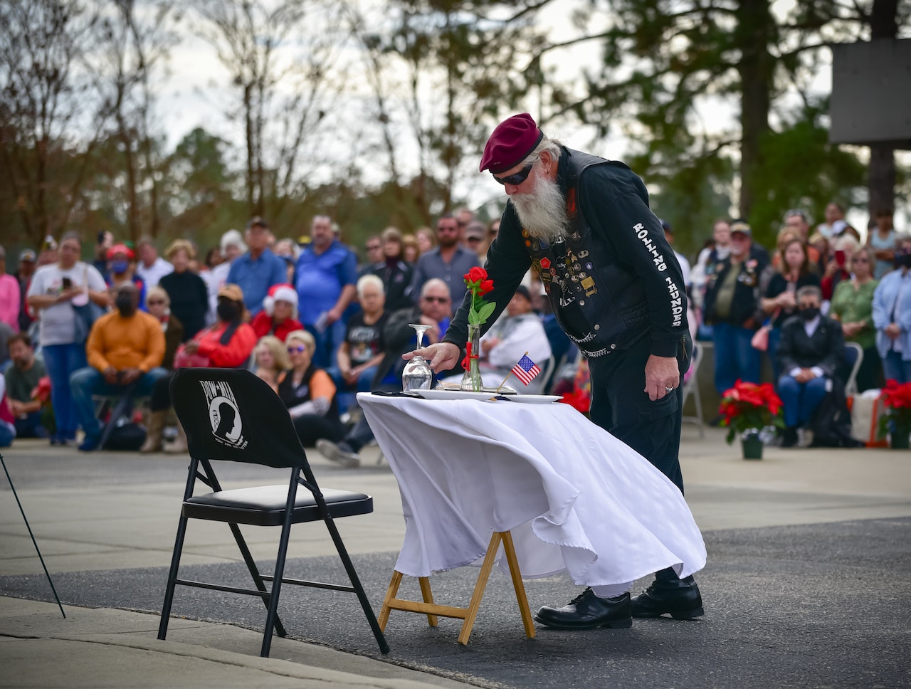 Man in Black Jacket and Pants Standing on Gray Concrete Floor | Veteran Car Donations
