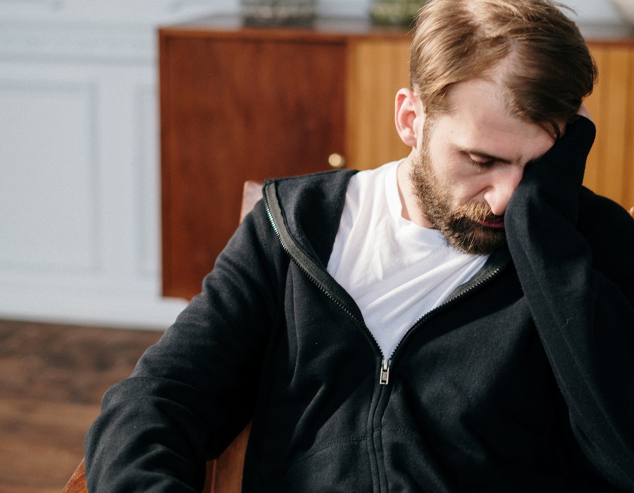 Man in Black Zip Up Jacket Sitting on Chair | Veteran Car Donations
