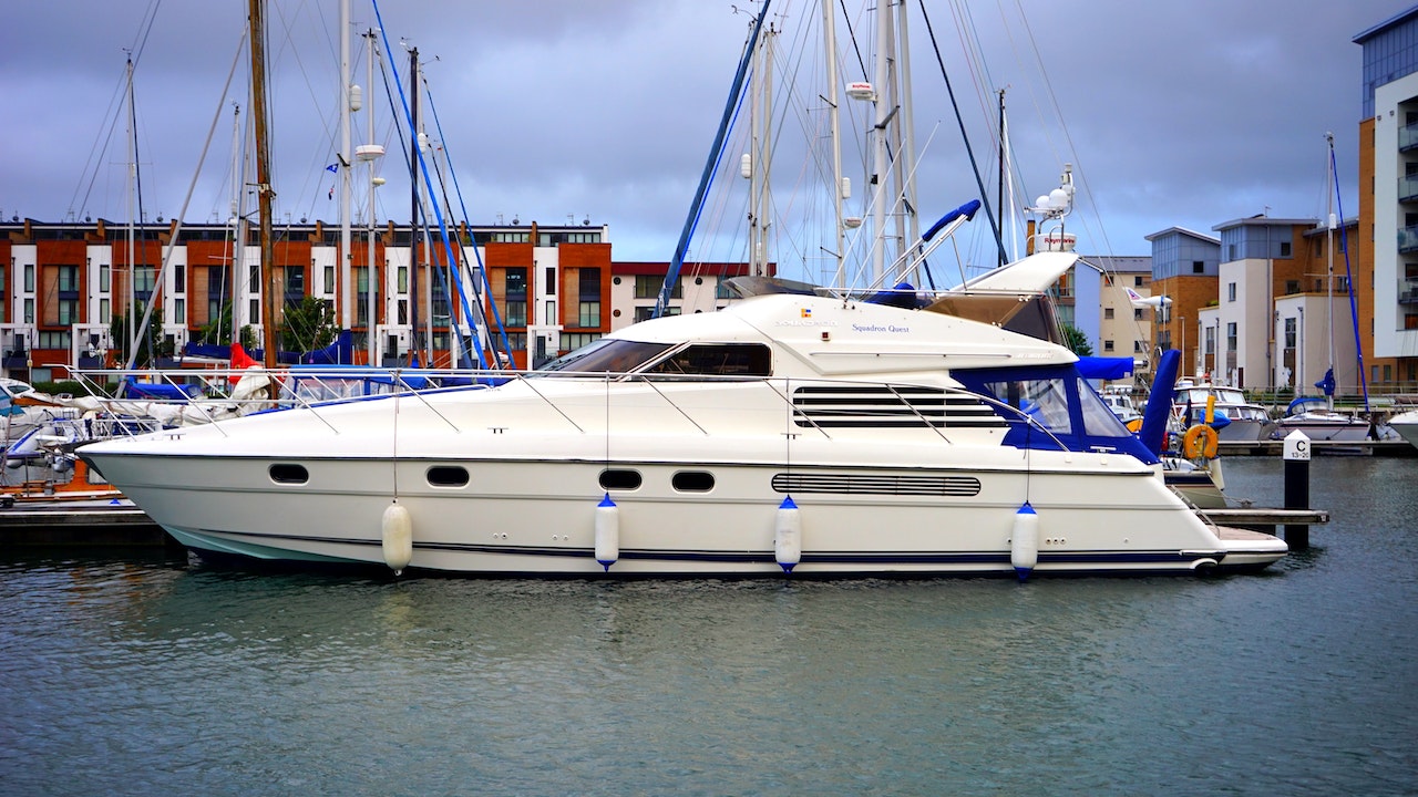 White with Blue Ropes Docked on Port | Veteran Car Donations