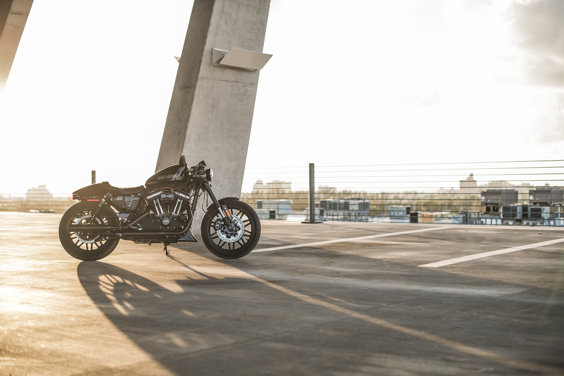 black motorcycle parked near grey concrete pillar photo | Veteran Car Donations