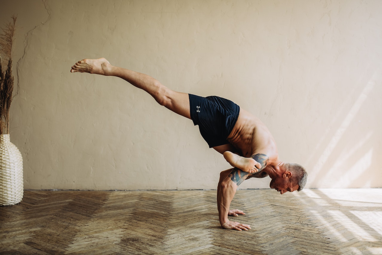 A Shirtless Man in Activewear Doing Yoga | Veteran Car Donations
