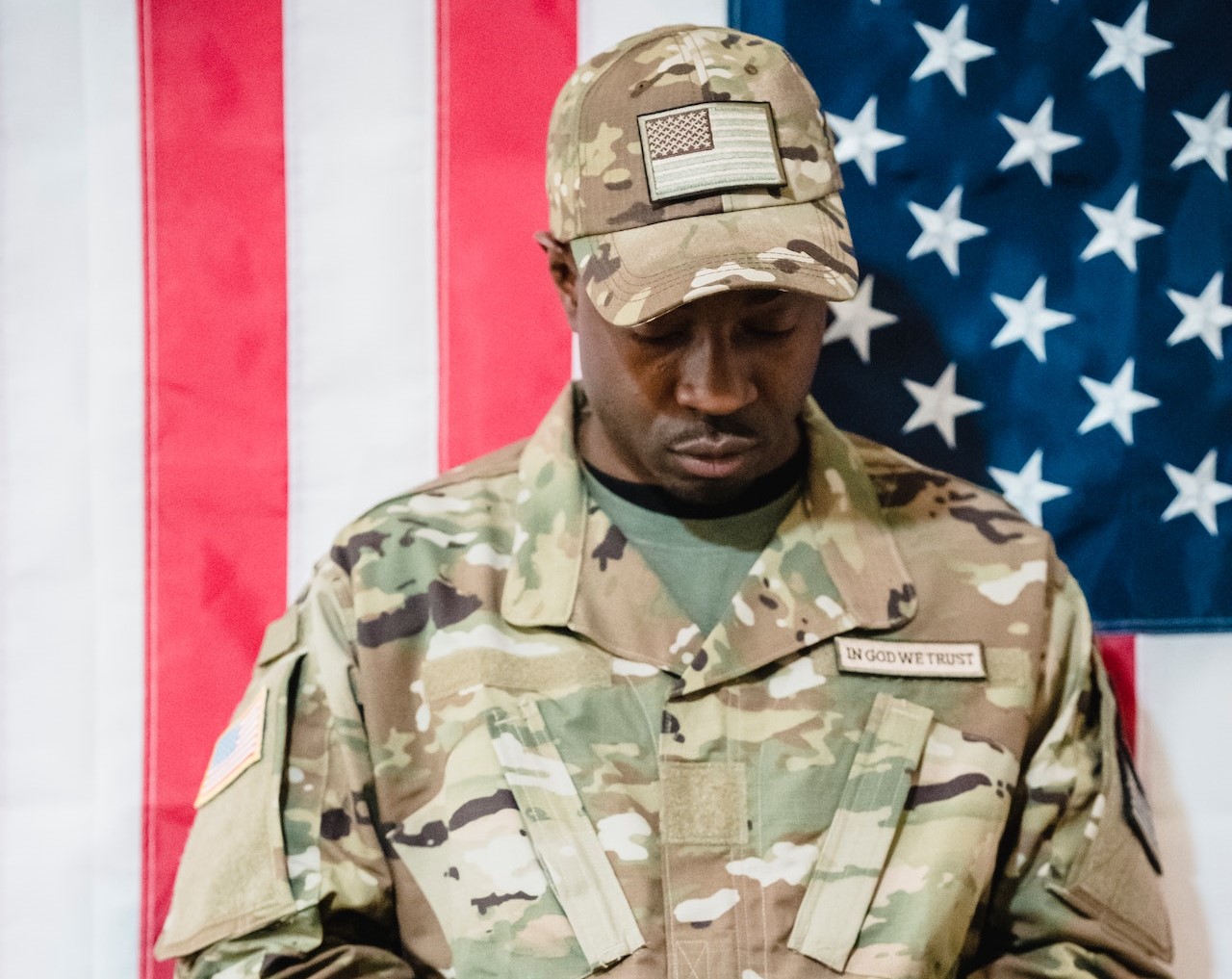 Portrait of a Soldier with a Flag in the Background | Veteran Car Donations
