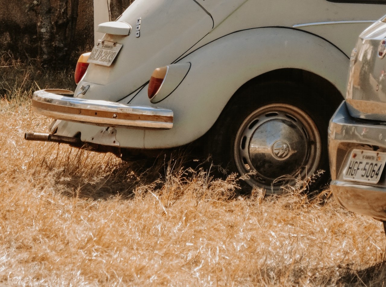 A Volkswagen Beetle Parked on the Grass | Veteran Car Donations

