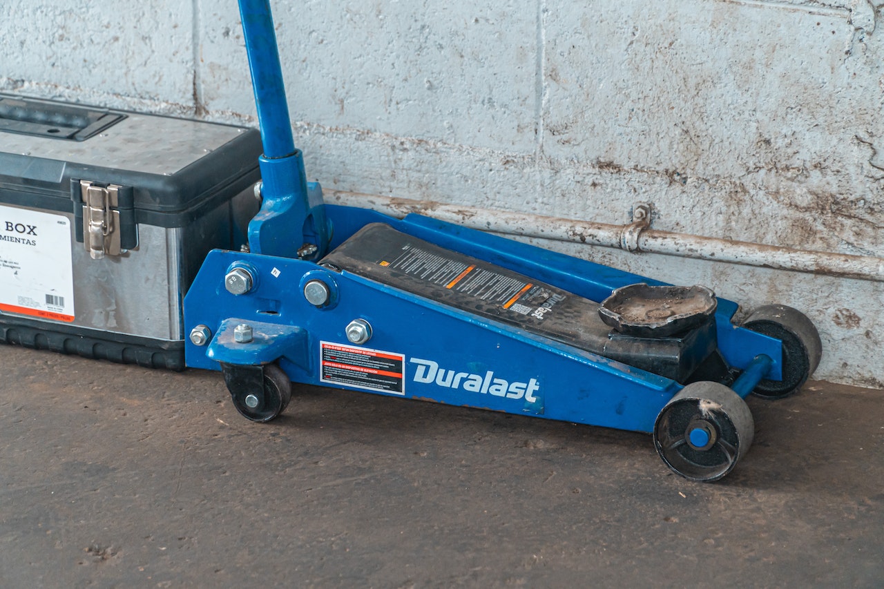 Blue Tool Jack Lift Car For Repair Beside A Tool Box | Veteran Car Donations