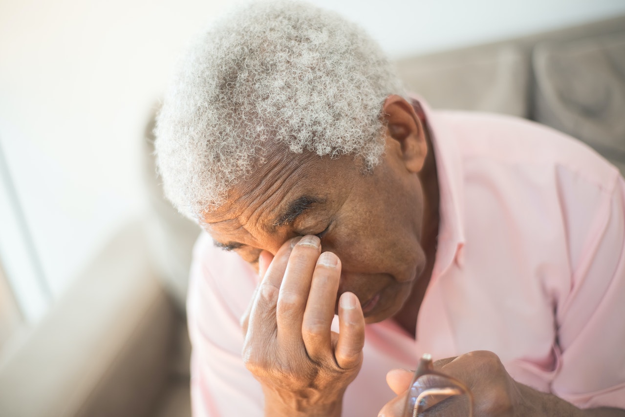 A Close-Up Shot of a Man in a Pink Shirt Grieving | Veteran Car Donations
