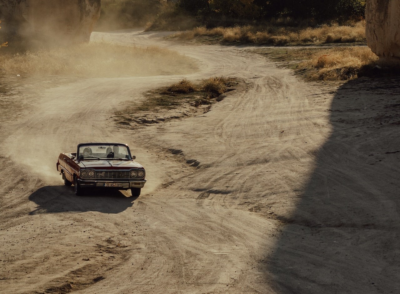 Car on Desert Between Rocks | Veteran Car Donations
