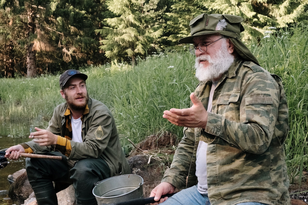 Man in Brown Jacket Holding Gray Bucket | Veteran Car Donations
