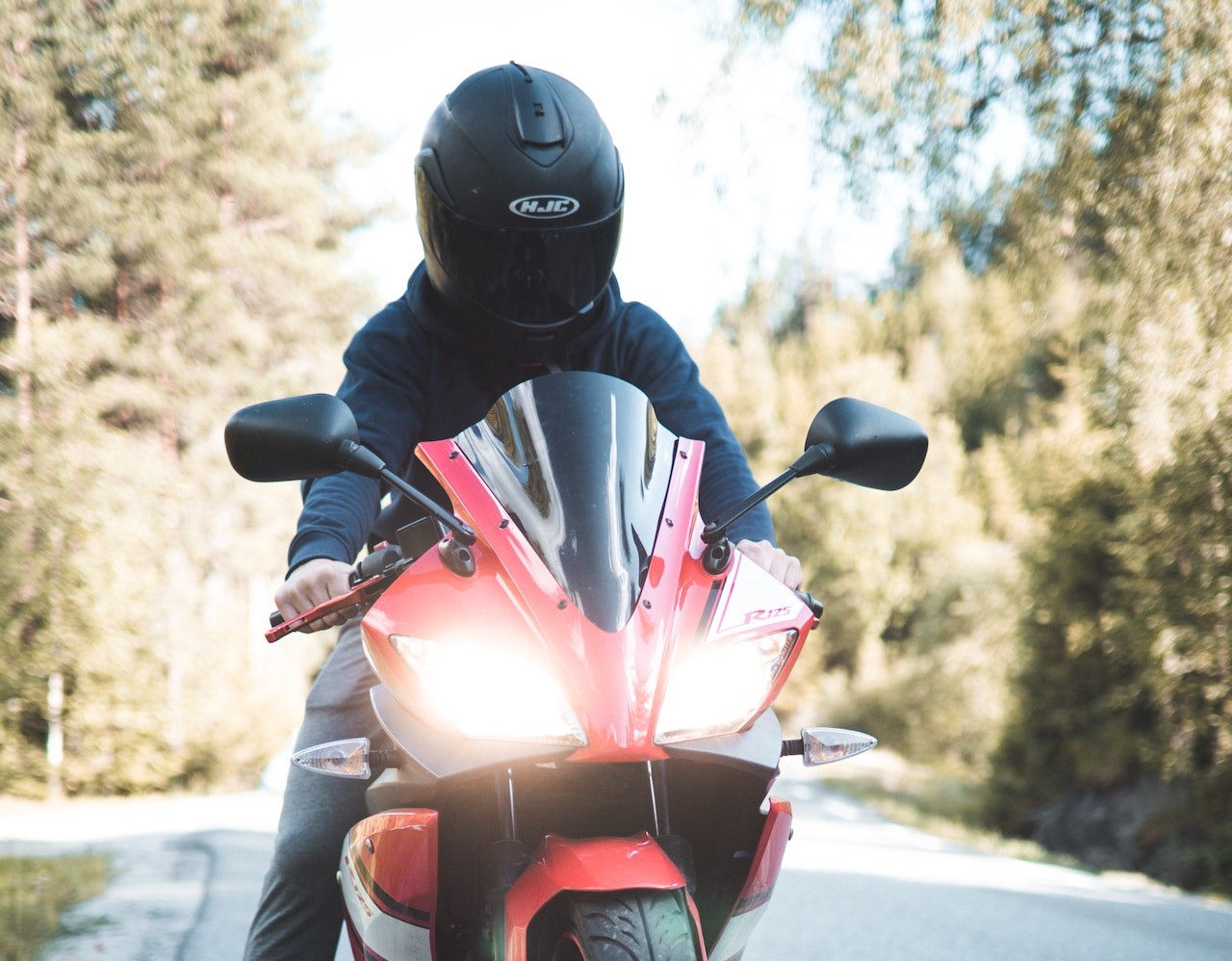 Person riding red sports bike | Veteran Car Donations