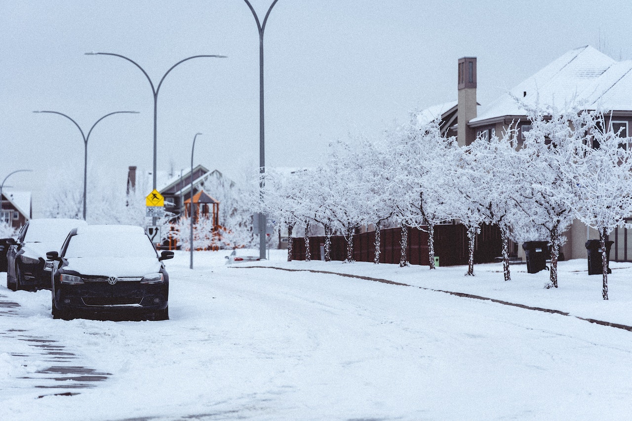 Cars Parked on Snow Covered Road and Trees | Veteran Car Donations
