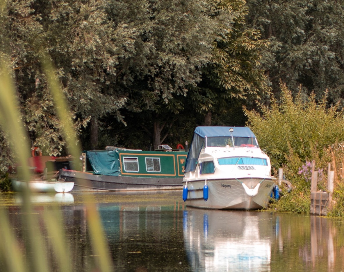 Boat parked on a River | Veteran Car Donations