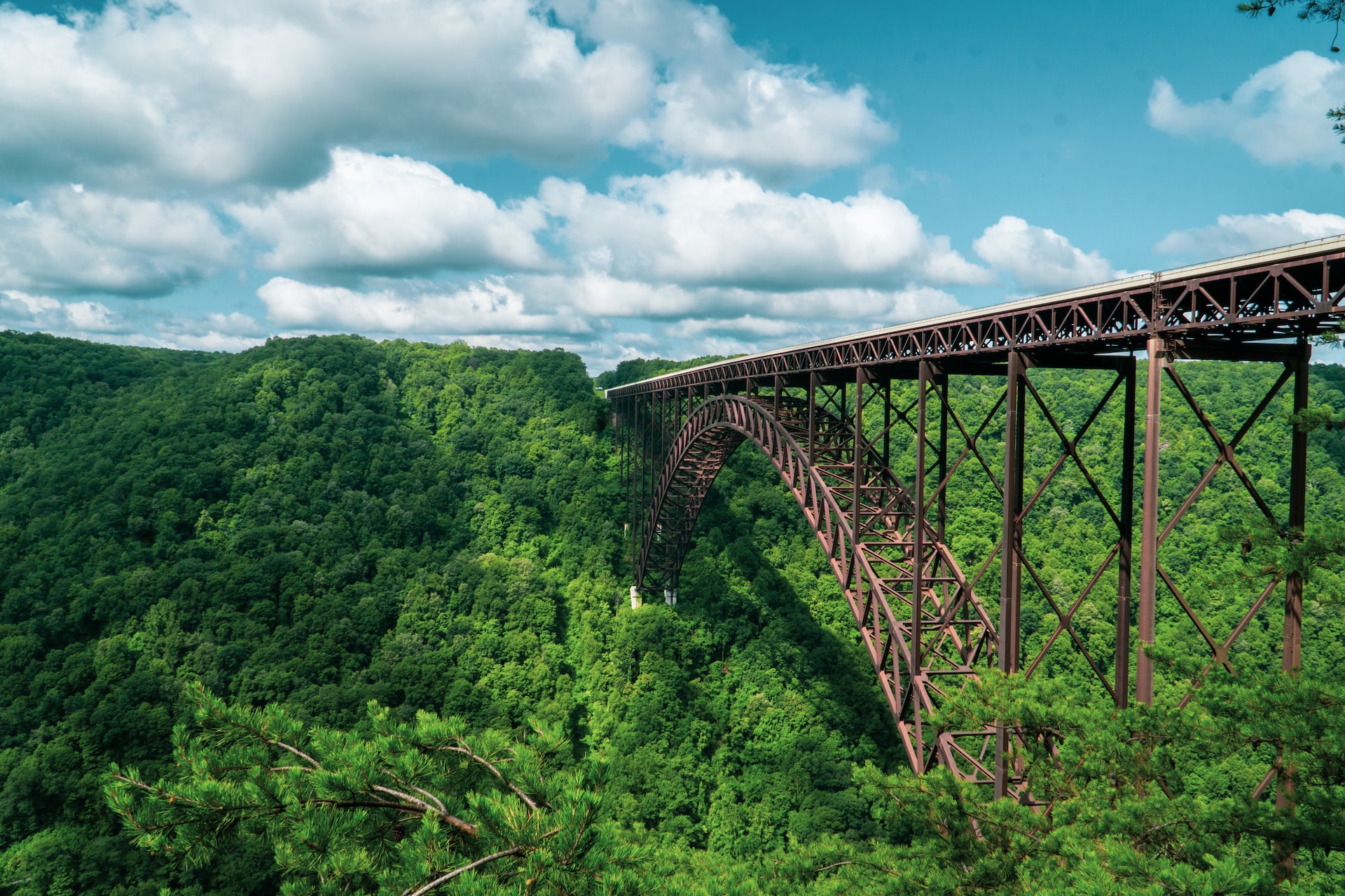 Long Metal Bridge Over a Green Trees | Veteran Car Donations