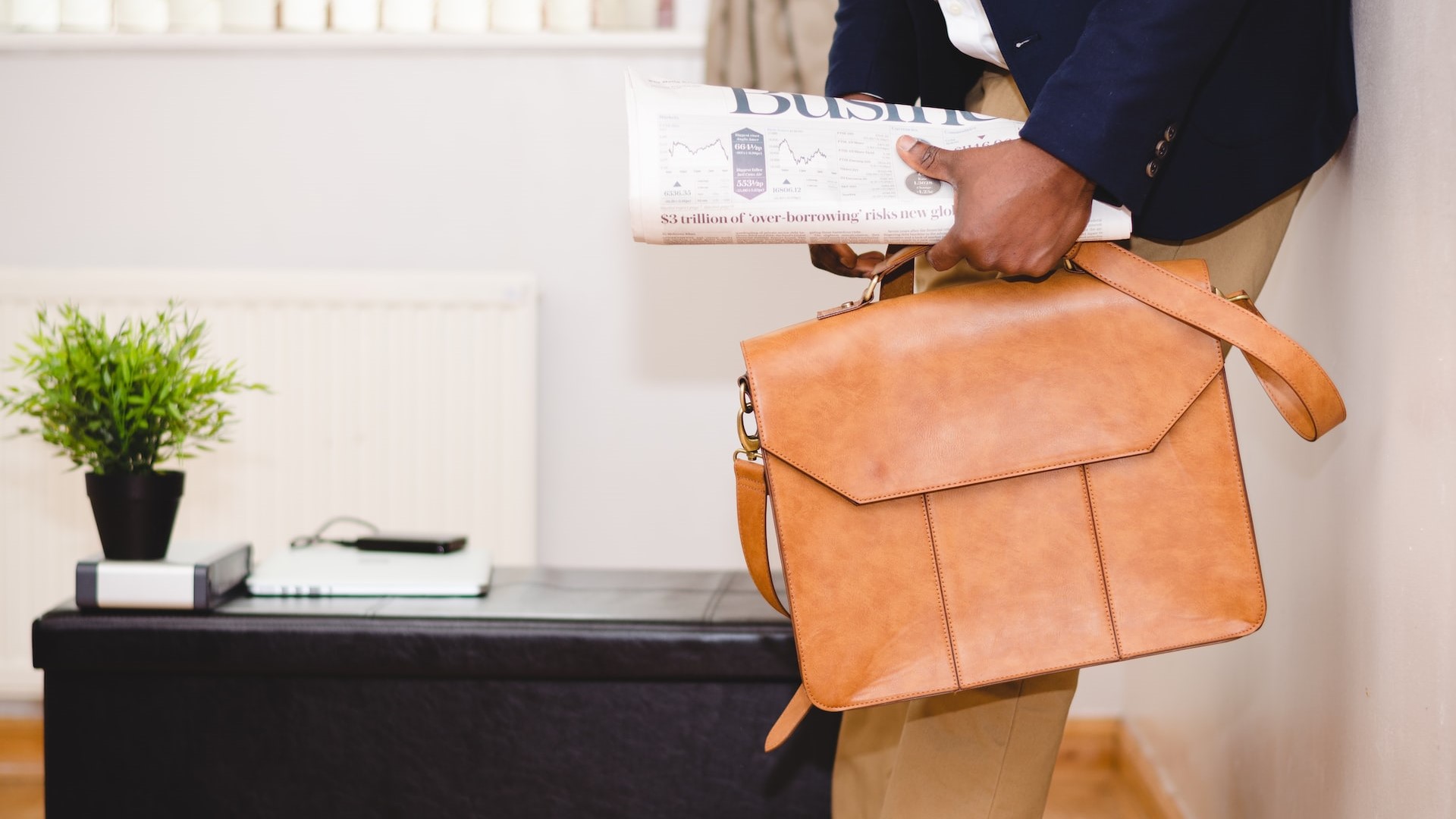 Man Holding Brown Leather Bag | Veteran Car Donations
