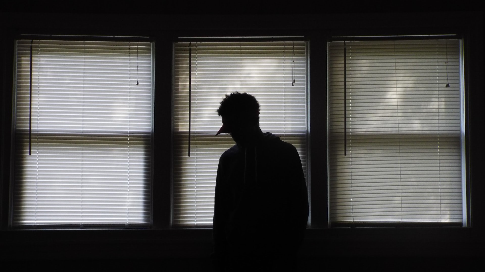 Man Standing in Front of the Window Blinds | Veteran Car Donations
