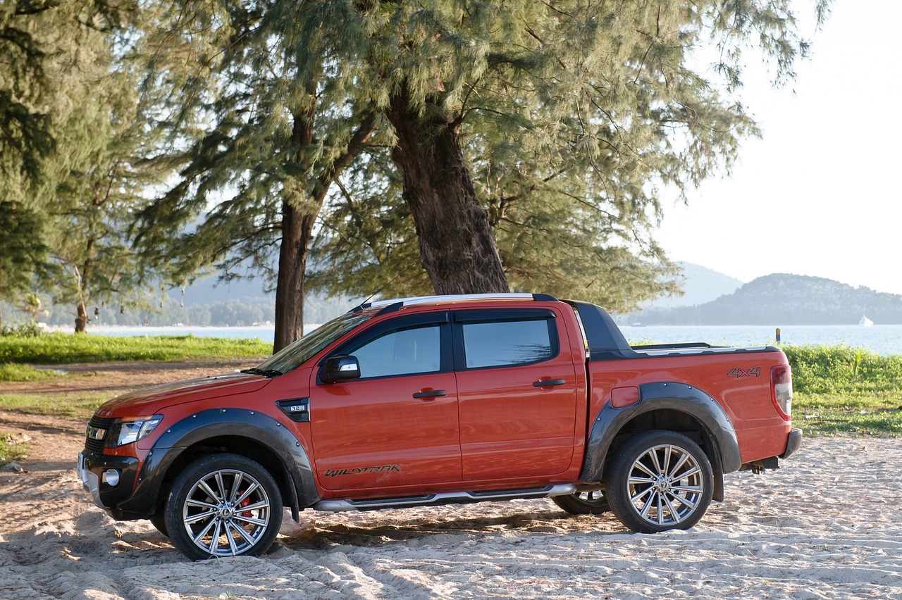 Orange Wildtrak Pickup at the Beach | Veteran Car Donations