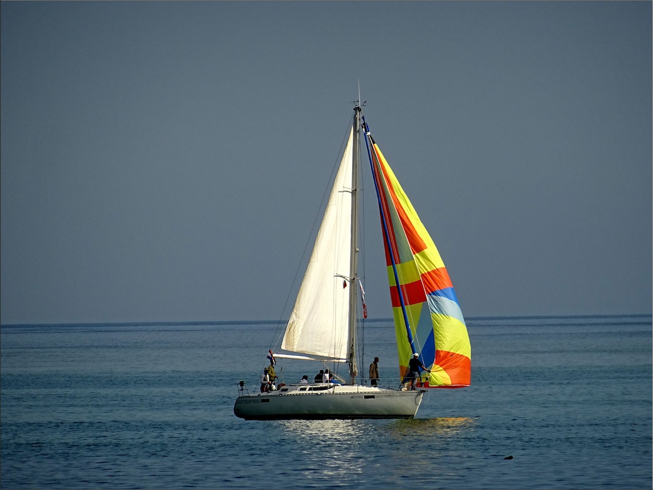 People Riding a White Sailboat | Veteran Car Donations