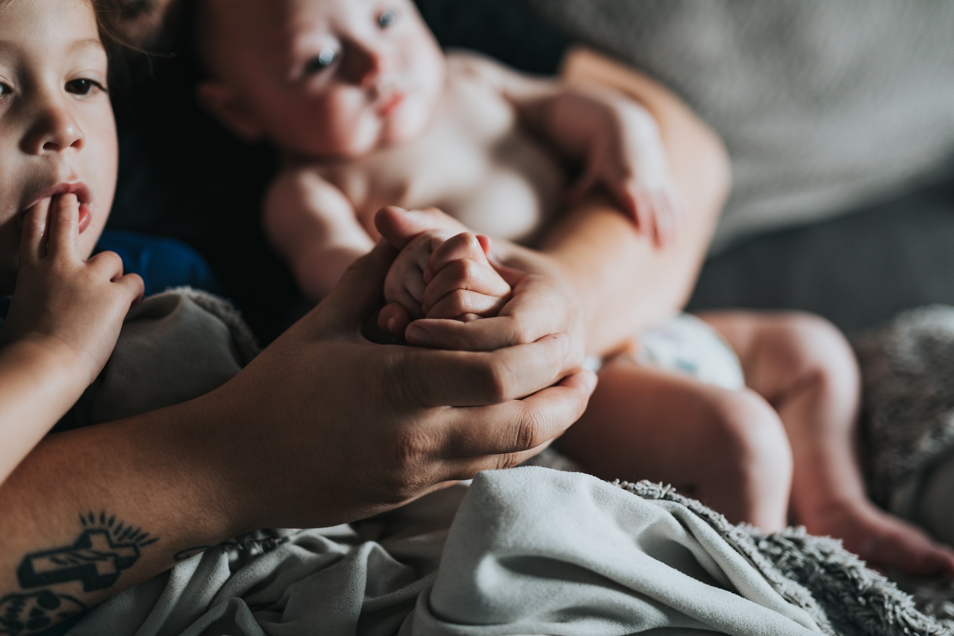 Person Holding Babies | Veteran Car Donations
