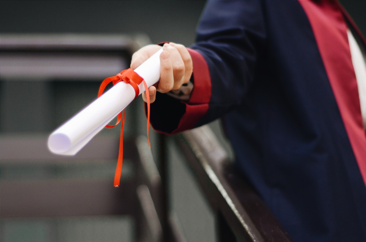 Person Holding White Scroll | Veteran Car Donations
