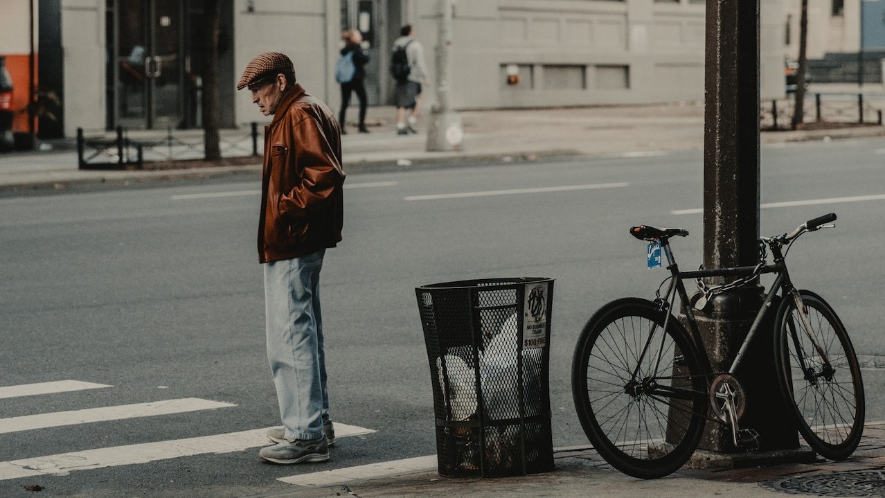 Photo of Man Standing in Pedestrian Lane | Veteran Car Donations
