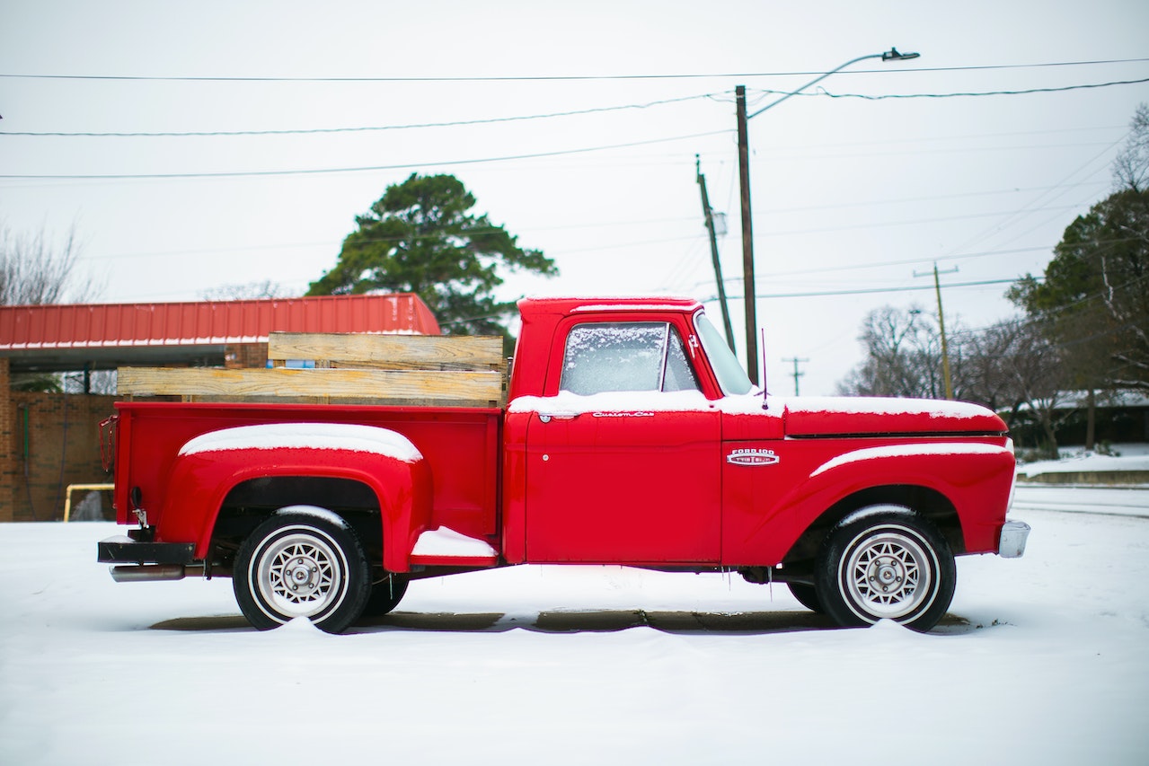 Red Classic Truck on snow | Veteran Car Donations