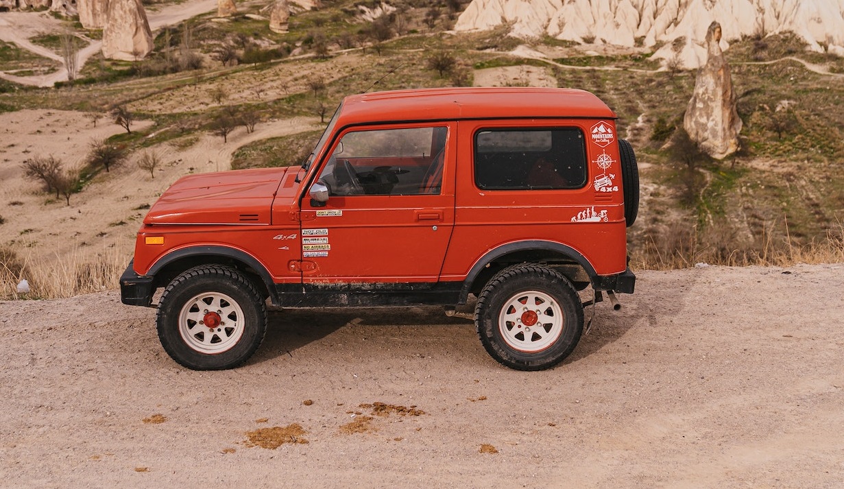 Red SUV parked on a canyon | Veteran Car Donations