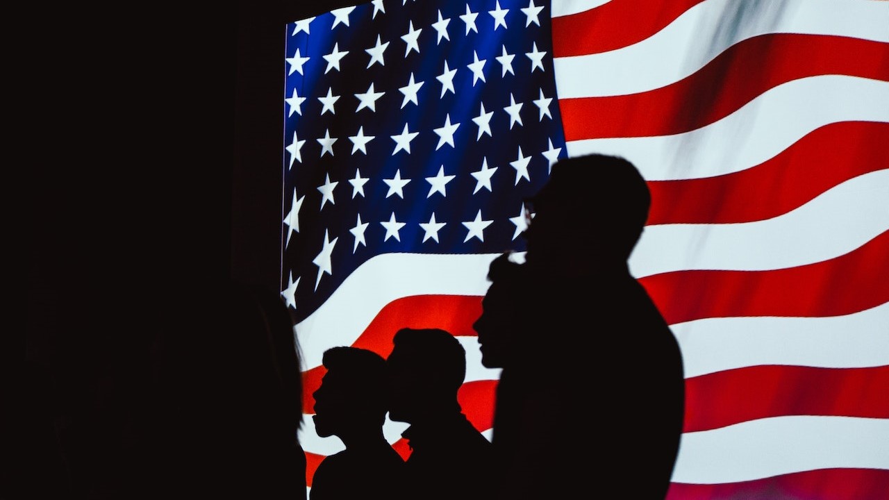 Silhouette of People Beside Usa Flag | Veteran Car Donations