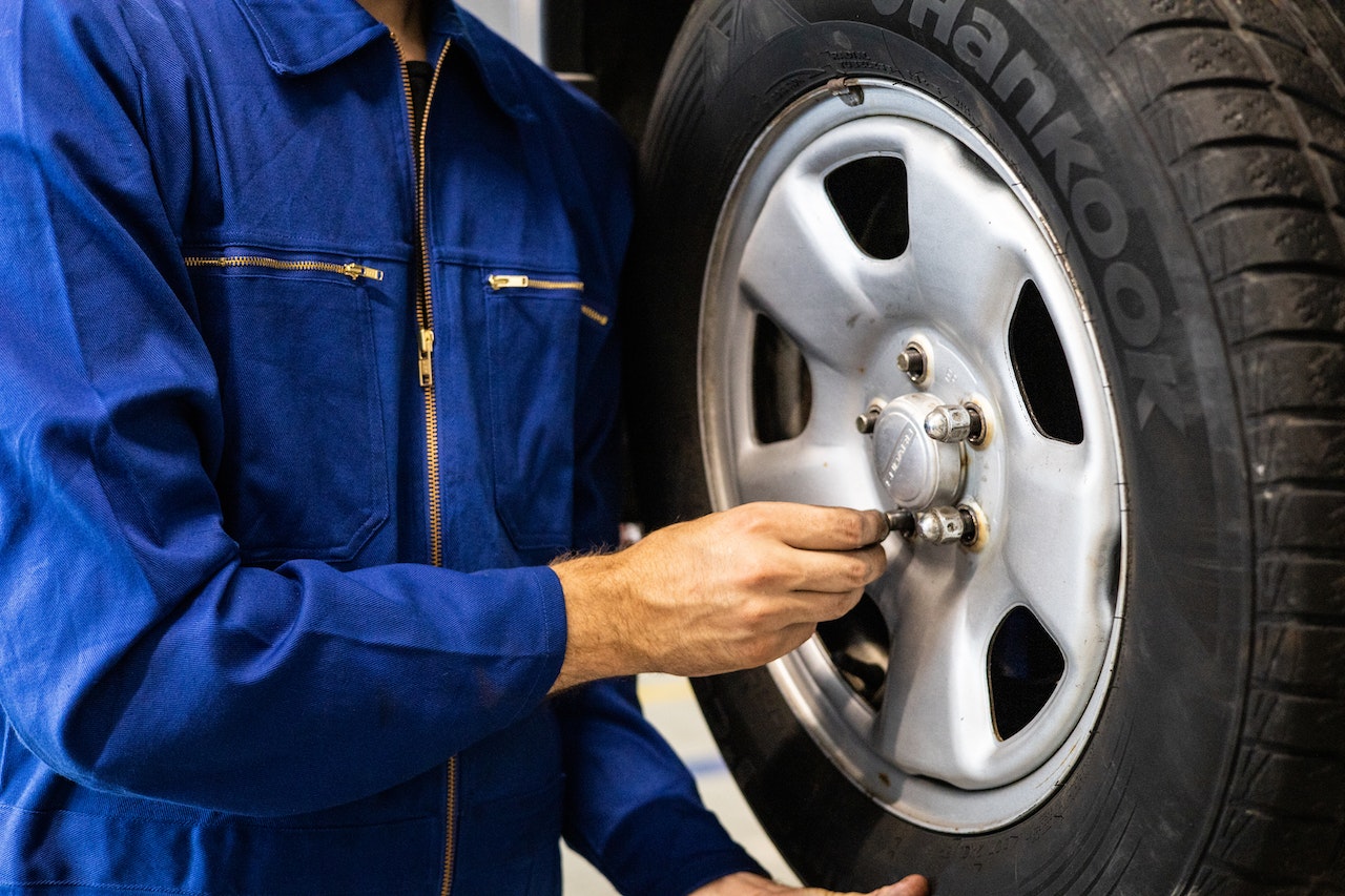 A Person Holding a Tire | Veteran Car Donations