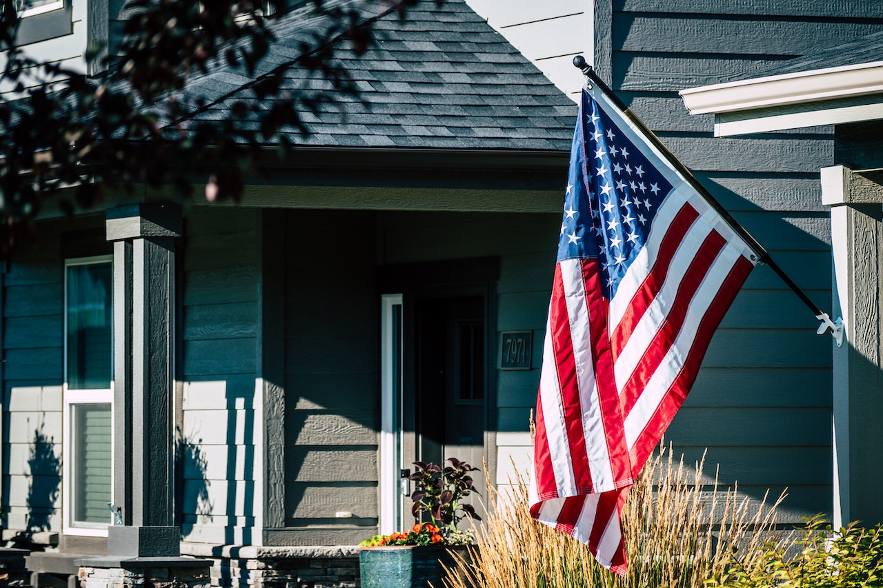 American Flag Waving Outside A House | Veteran Car Donations
